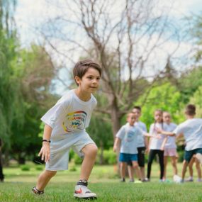 Group of children enjoying outdoor playtime in a green park during summer.